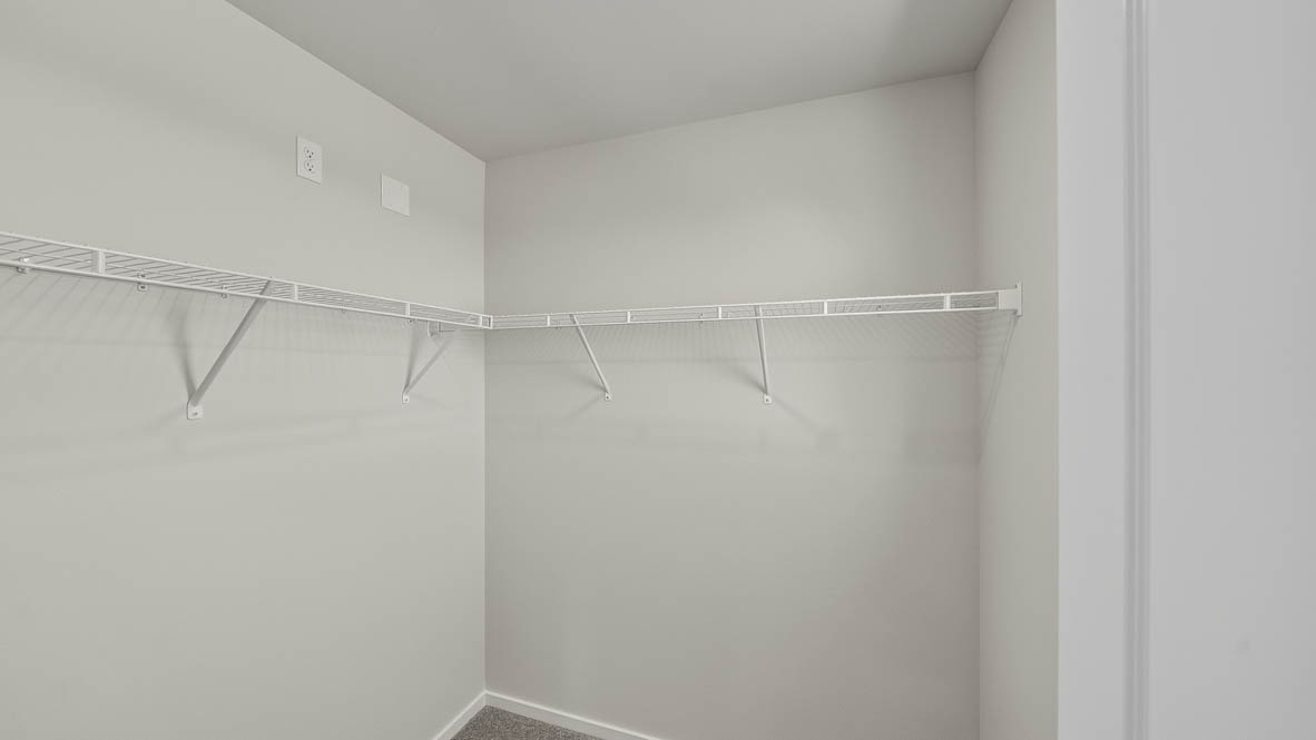 Primary bedroom walk-in closet with wire shelves