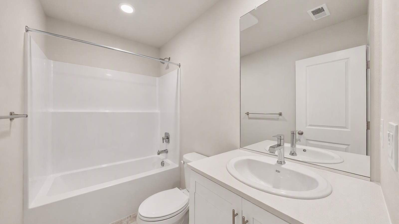 Hall bathroom with combination tub/shower and quartz counters