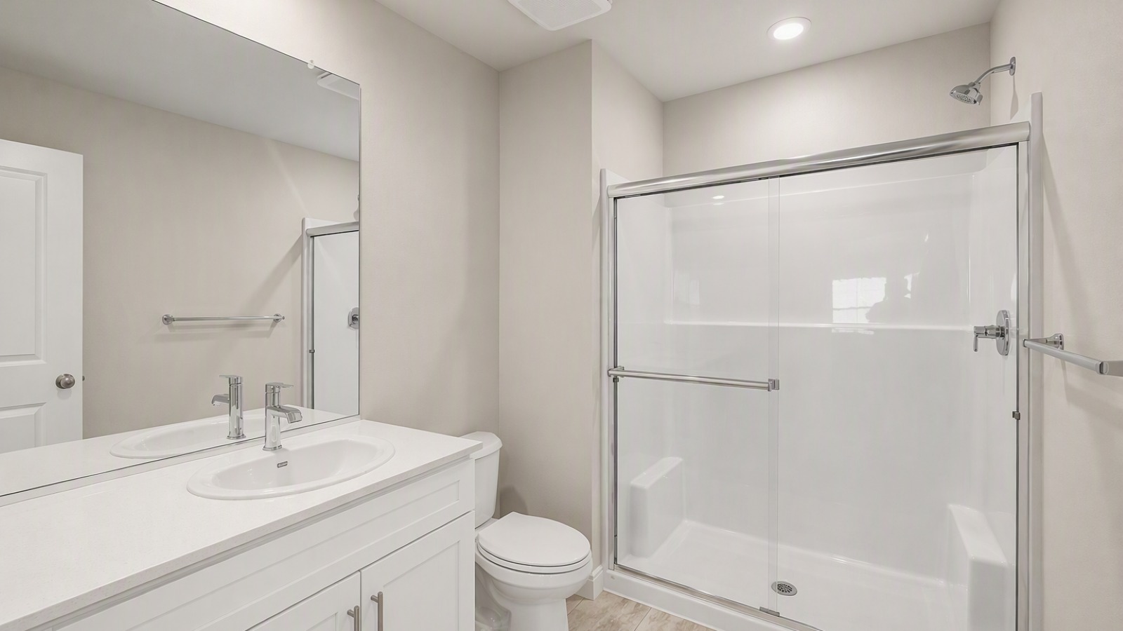 Primary bathroom with quartz counters and a walk-in shower