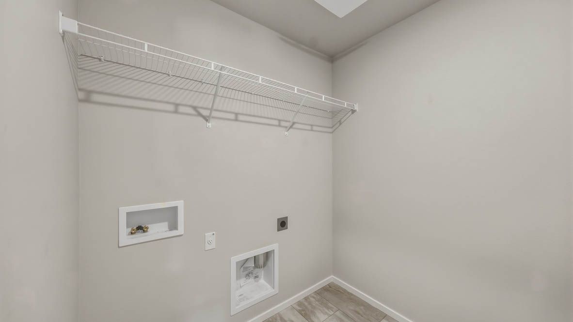 Laundry room with wire shelves and washer and dryer hookups