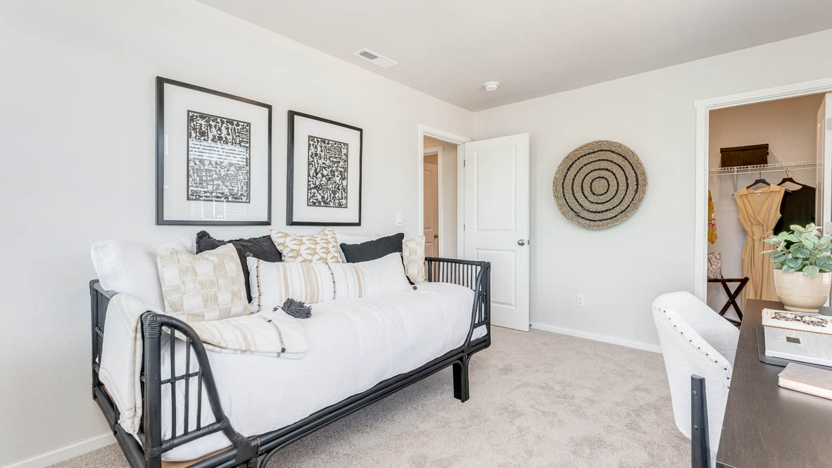 Terrace at Pleasant Valley bedroom with a baby crib, a desk with a chair, two decorations, carpet, and a closet
