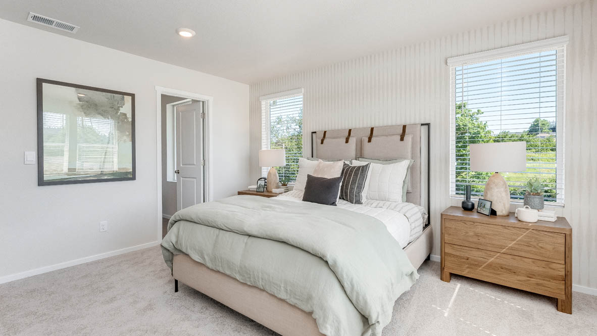 Terrace at Pleasant Valley Primary Bedroom with carpet, a bed with gray bedding, brown nightstands with lamps, and windows