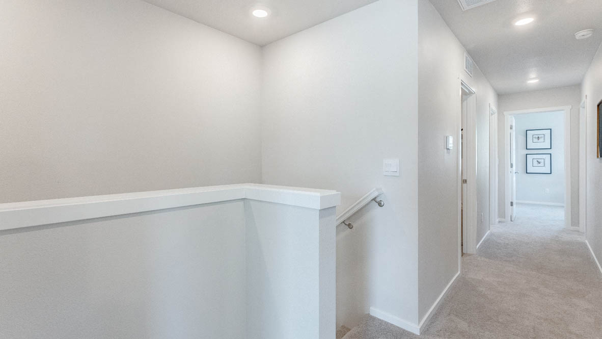 Terrace at Pleasant Valley Hallway with the staircase, carpet, and white walls