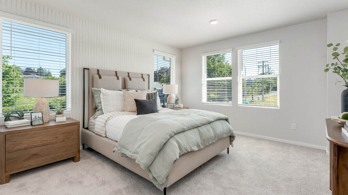 Terrace at Pleasant Valley Primary Bedroom with carpet, a bed with gray bedding, brown nightstands with lamps, and windows