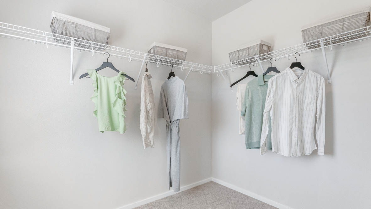 Primary bedroom walk-in closet with wire shelves