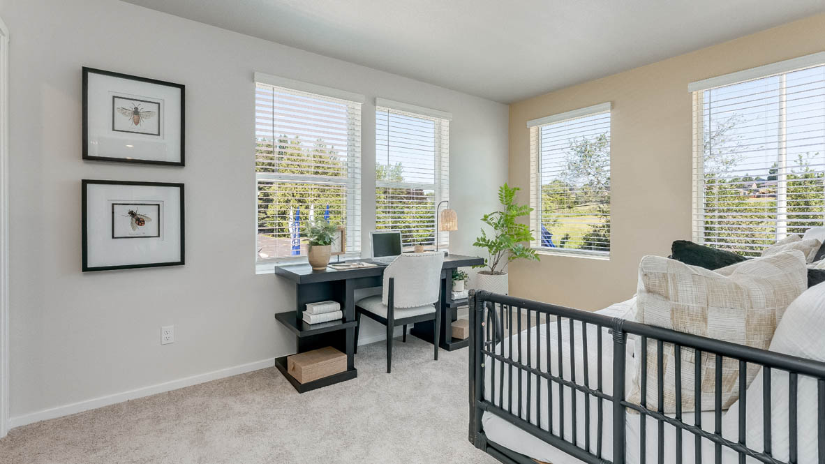 Terrace at Pleasant Valley bedroom with a baby crib, a desk with a chair, two decorations, carpet, and windows