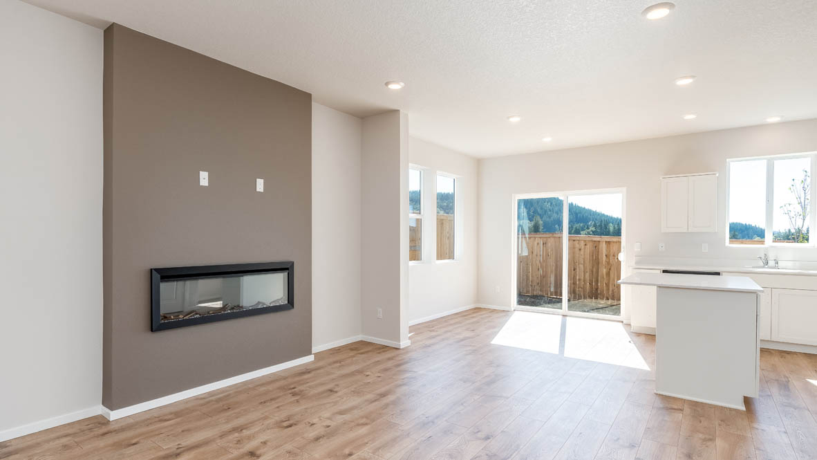 Terrace at Pleasant Valley great room and dining with fireplace, shiplap wall, kitchen island, and a sliding glass door
