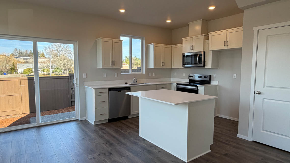 Terrace at Pleasant Valley kitchen with stainless steel appliances, solid surface countertops, a window, and laminate flooring