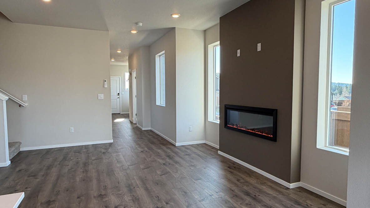 Terrace at Pleasant Valley great room and dining with fireplace, shiplap wall, kitchen island, and a sliding glass door