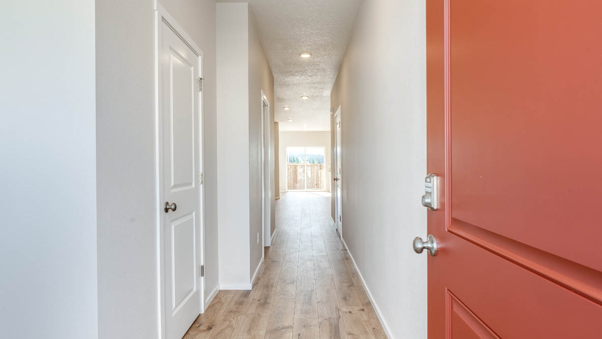Terrace at Pleasant Valley entry with red door and hallway, including the powder room to the left