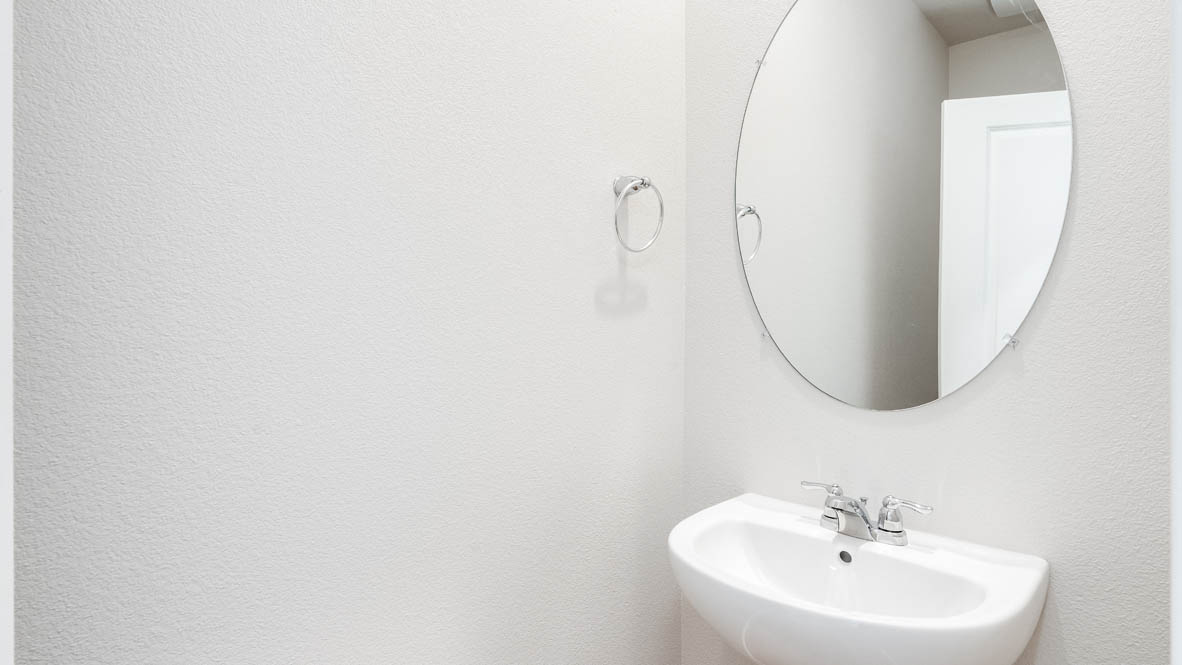 Terrace at Pleasant Valley Powder room with single sink vanity, oval mirror, and white walls