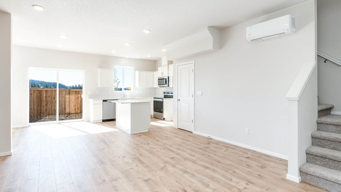 Terrace at Pleasant Valley kitchen and great room with laminate flooring, staircase, and the kitchen in the background