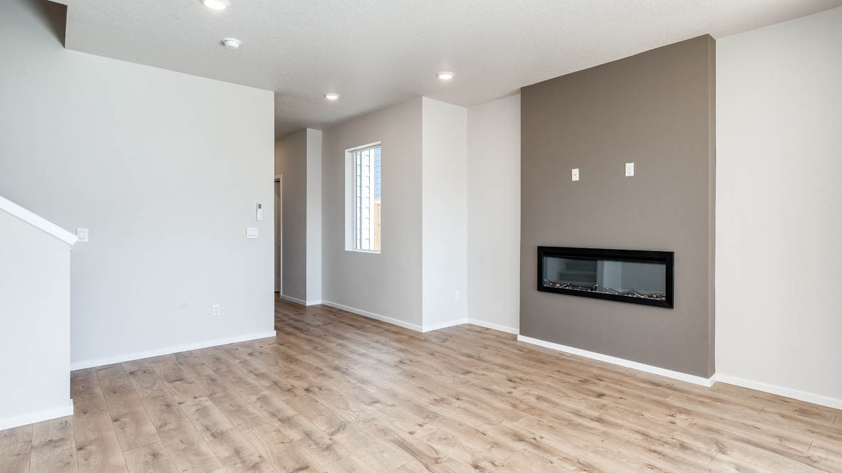 Terrace at Pleasant Valley great room with fireplace, shiplap wall, staircase, and the entry hallway in the background