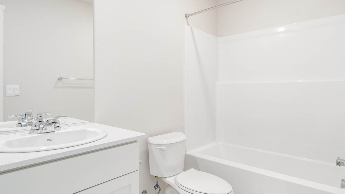 Terrace at Pleasant Valley bathroom with solid surface countertops, toilet, and bathtub