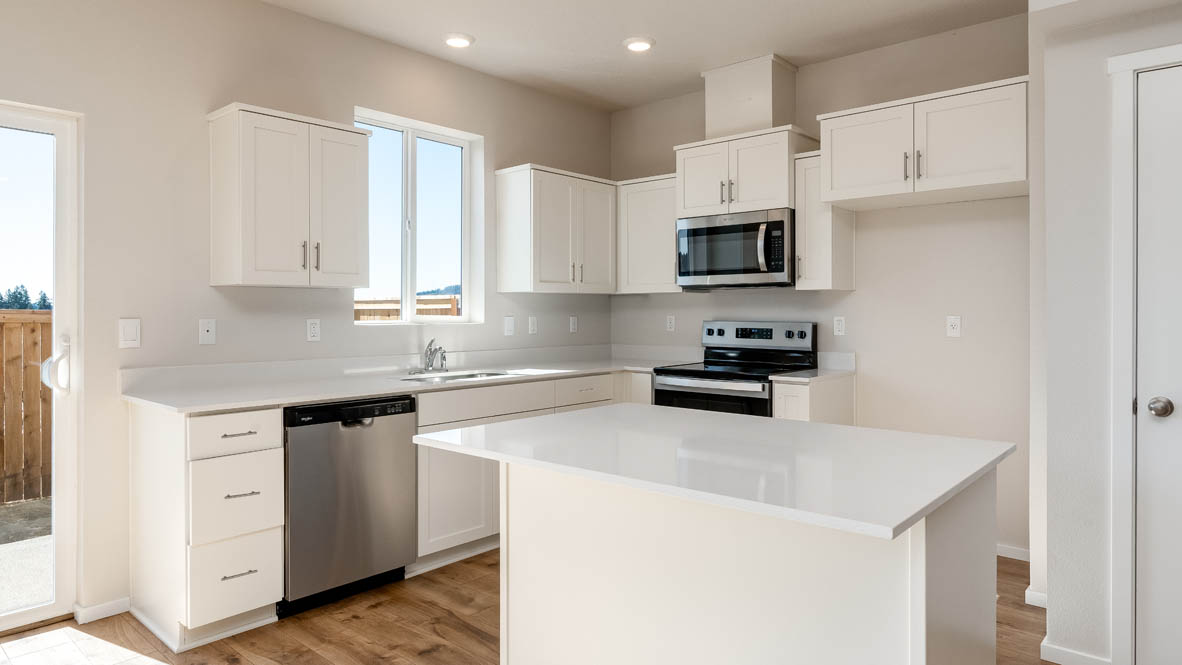 Terrace at Pleasant Valley kitchen with stainless steel appliances, solid surface countertops, a window, and laminate flooring