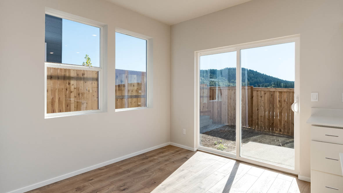 Terrace at Pleasant Valley dining room with windows, laminate flooring, and sliding glass door
