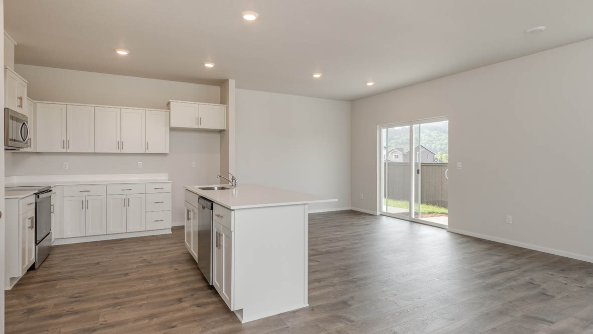 Terrace at Pleasant Valley kitchen with an island and white shaker style cabinets and laminate flooring and stainless steel appliances