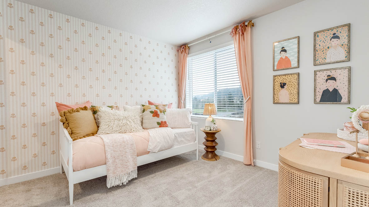Butler Creek Crossing Bedroom with a white bed frame and pink blanket, window with pink drapes, carpeting, and a wooden dresser