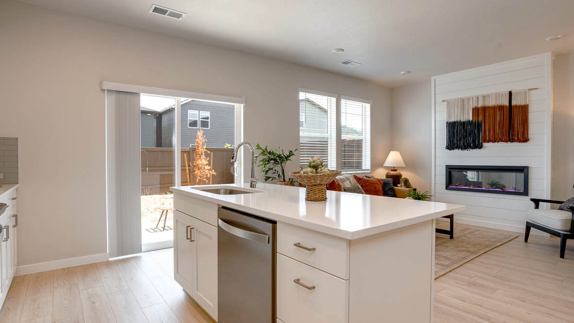 Butler Creek Crossing kitchen with shaker style cabinets and white solid surface countertops and full height backsplash