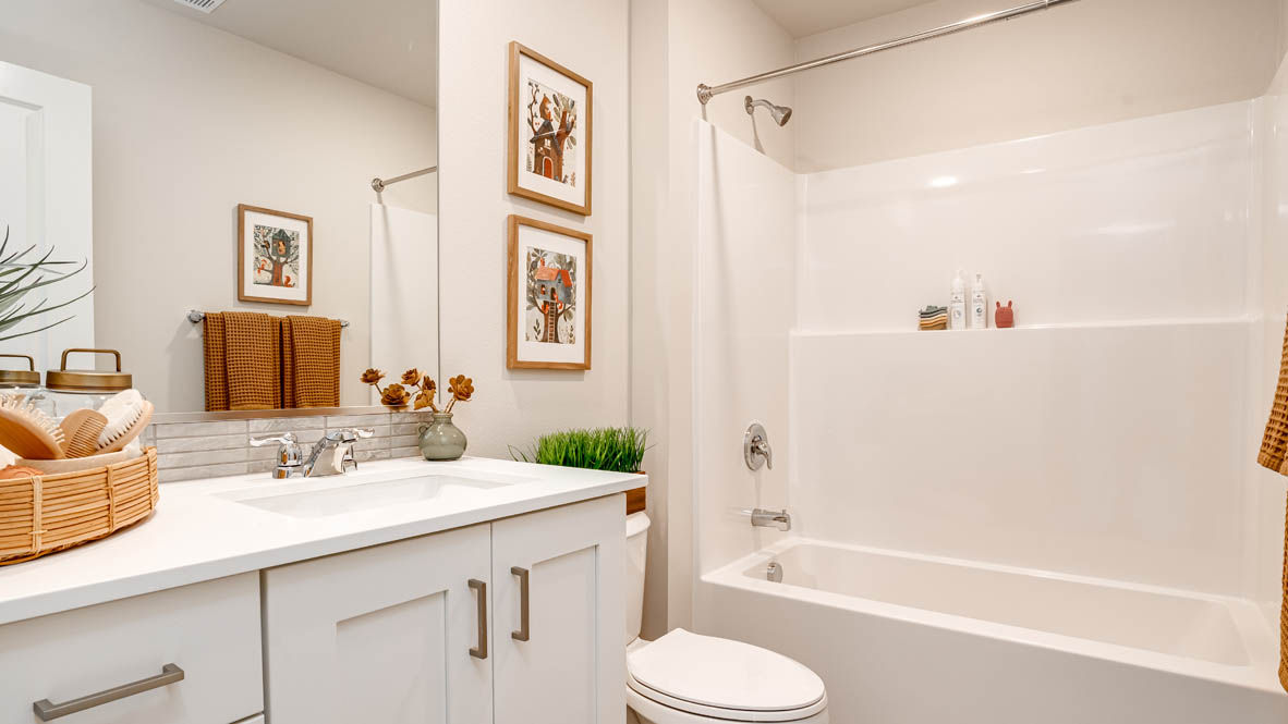 Butler Creek Crossing secondary bathroom with single sink vanity and tub shower
