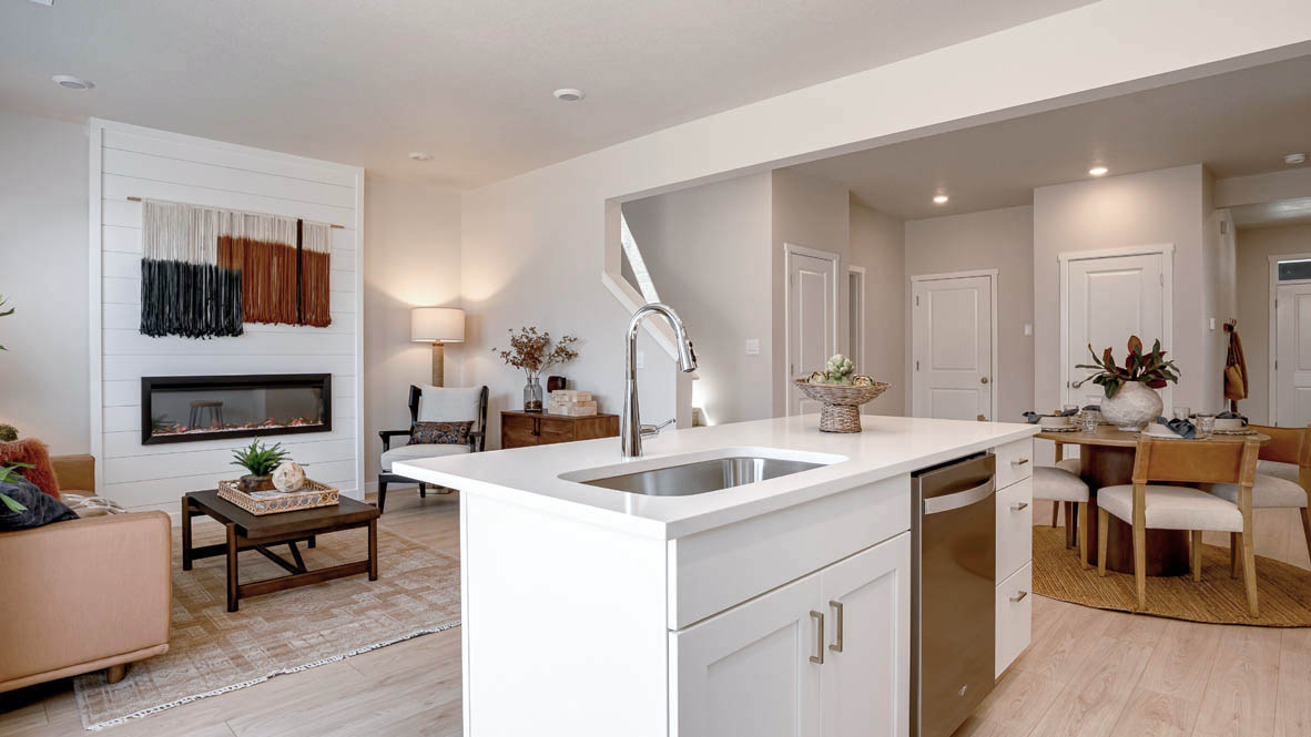Butler Creek Crossing kitchen with shaker style cabinets and white solid surface countertops and full height backsplash