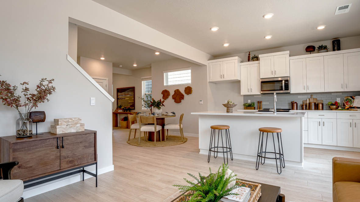 Butler Creek Crossing kitchen with shaker style cabinets and white solid surface countertops and full height backsplash