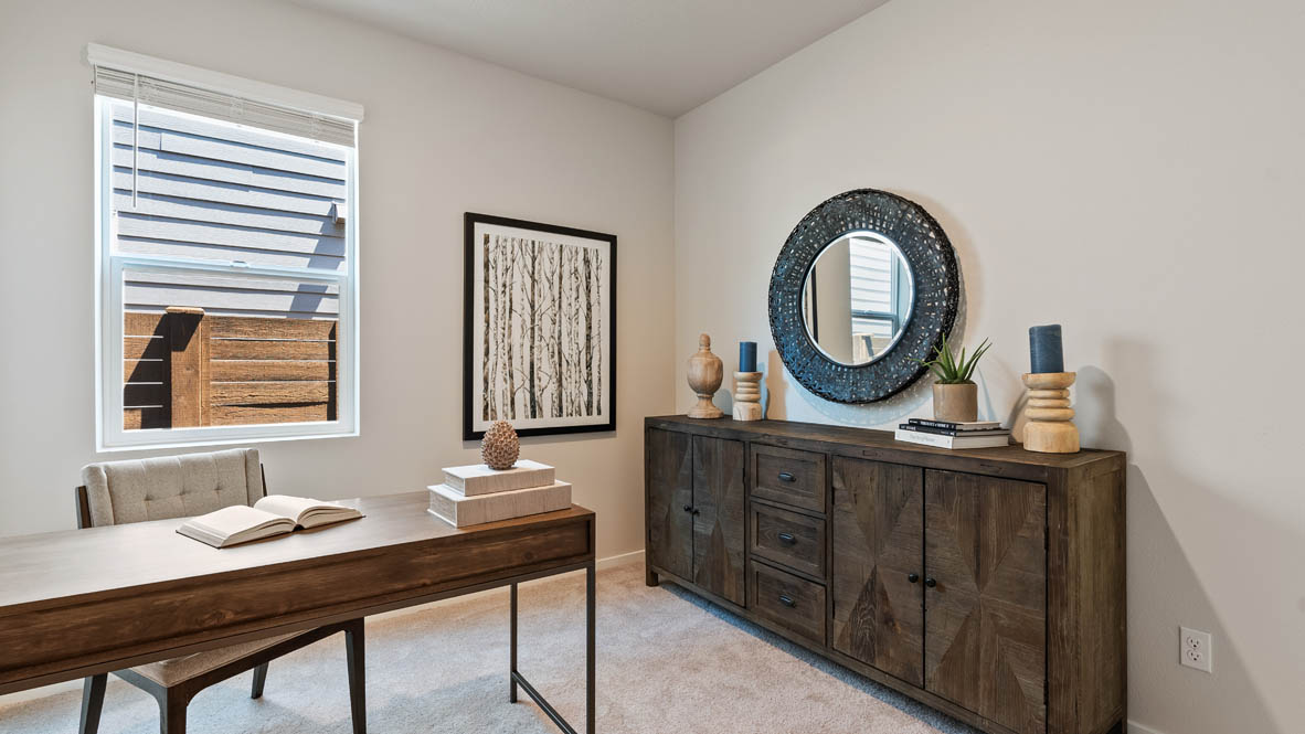 Butler Creek Crossing bedroom with office desk, window, dresser, and circle mirror