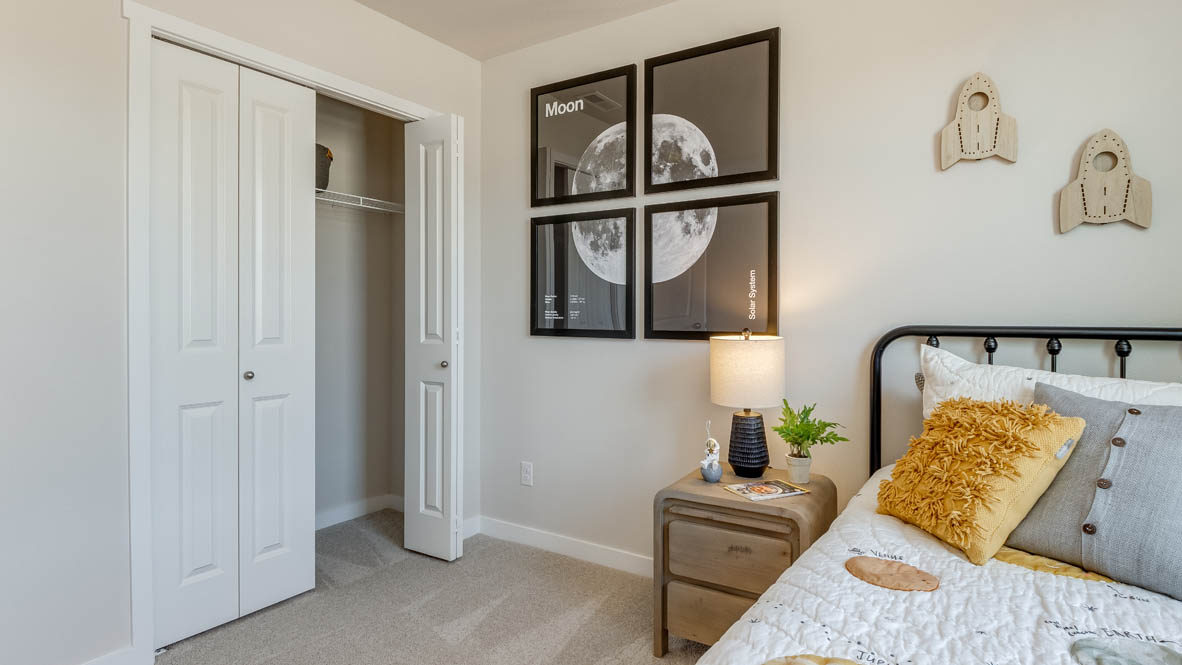 Butler Creek Crossing with carpet and dresser, bedroom, four pictures of the moon