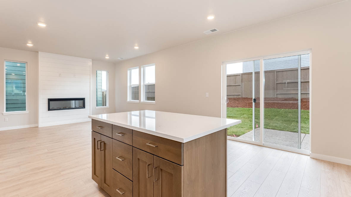 Butler Creek Crossing kitchen with window, stainless steel appliances, drawers, white stained cabinets, and pantry