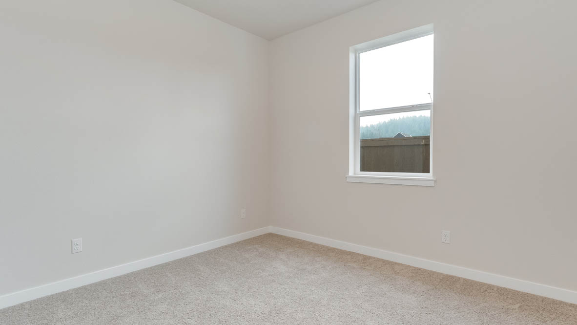 Butler Creek Crossing bedroom with window, carpet, and white walls