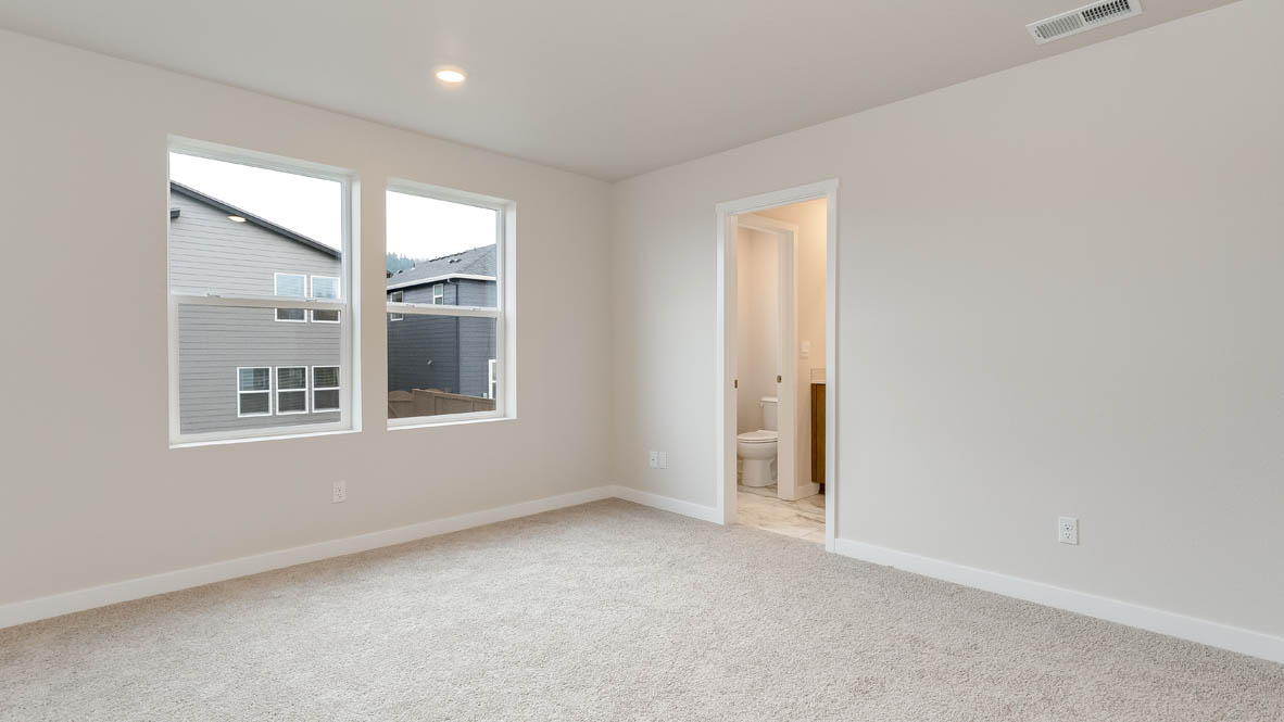 Butler Creek Crossing primary bedroom with carpet, windows