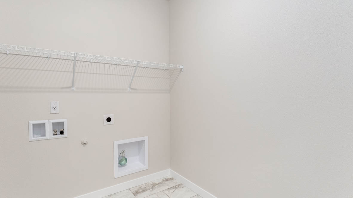 Butler Creek Crossing laundry room with white wire shelving