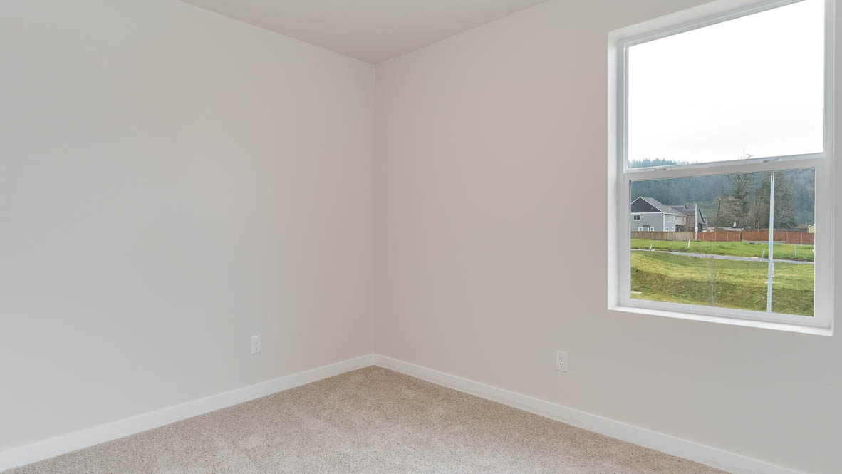 Butler Creek Crossing bedroom with window, carpet, and white walls