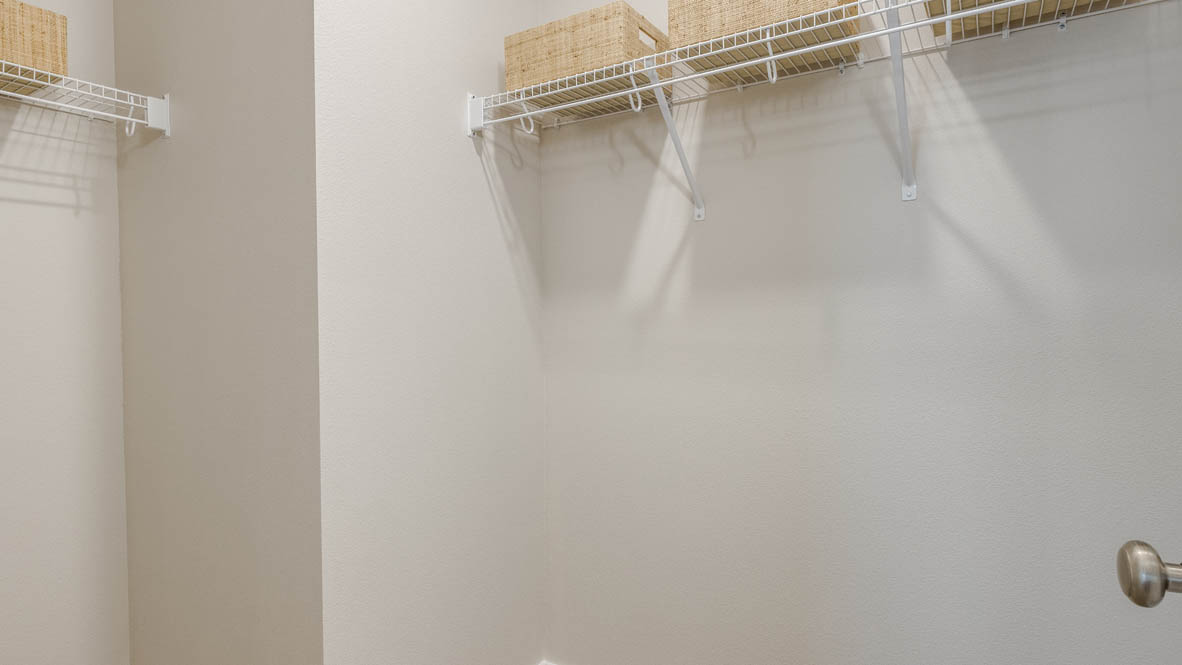 Butler Creek Crossing walk-in closet with white wire hangers