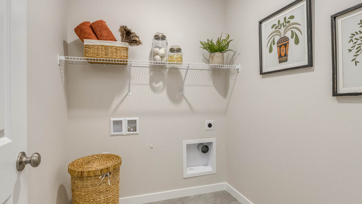 Butler Creek Crossing laundry room with white wire shelving, and a hamper