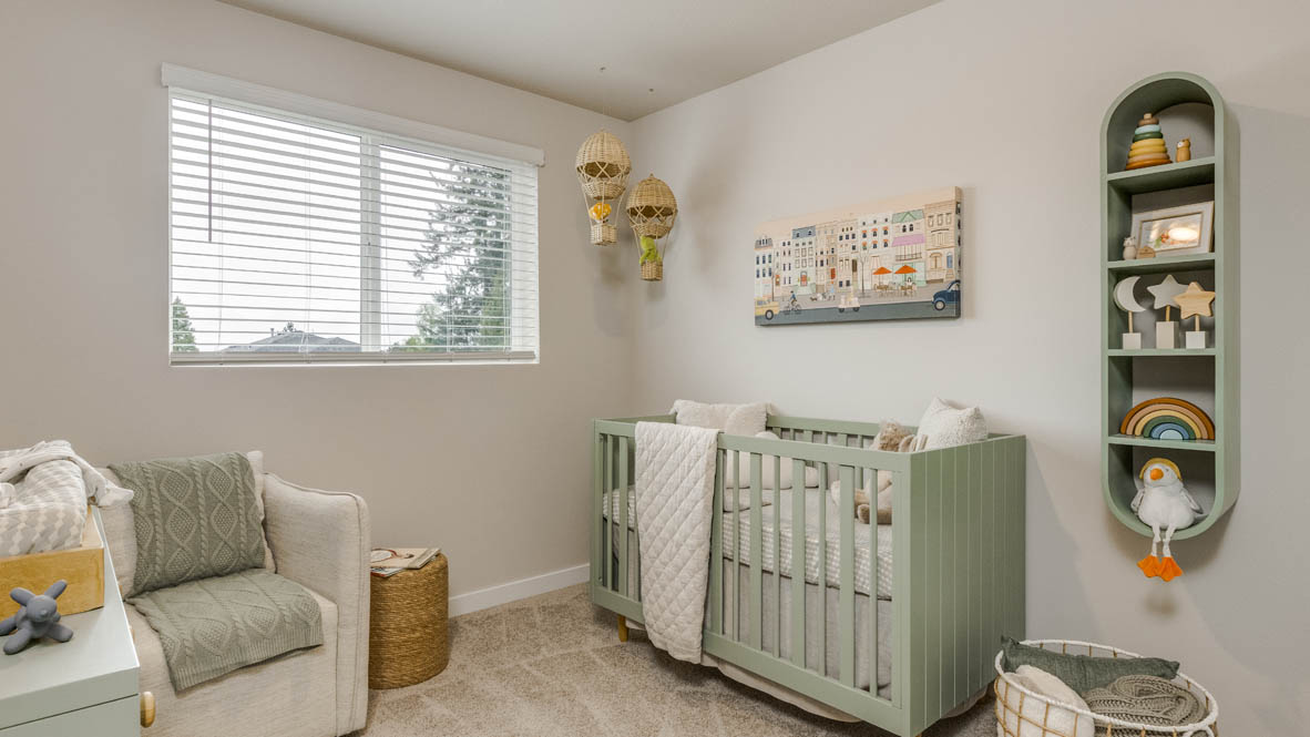 Butler Creek Crossing bedroom with side table and a lamp, bed, paintings, desk with a chair, and window with shades