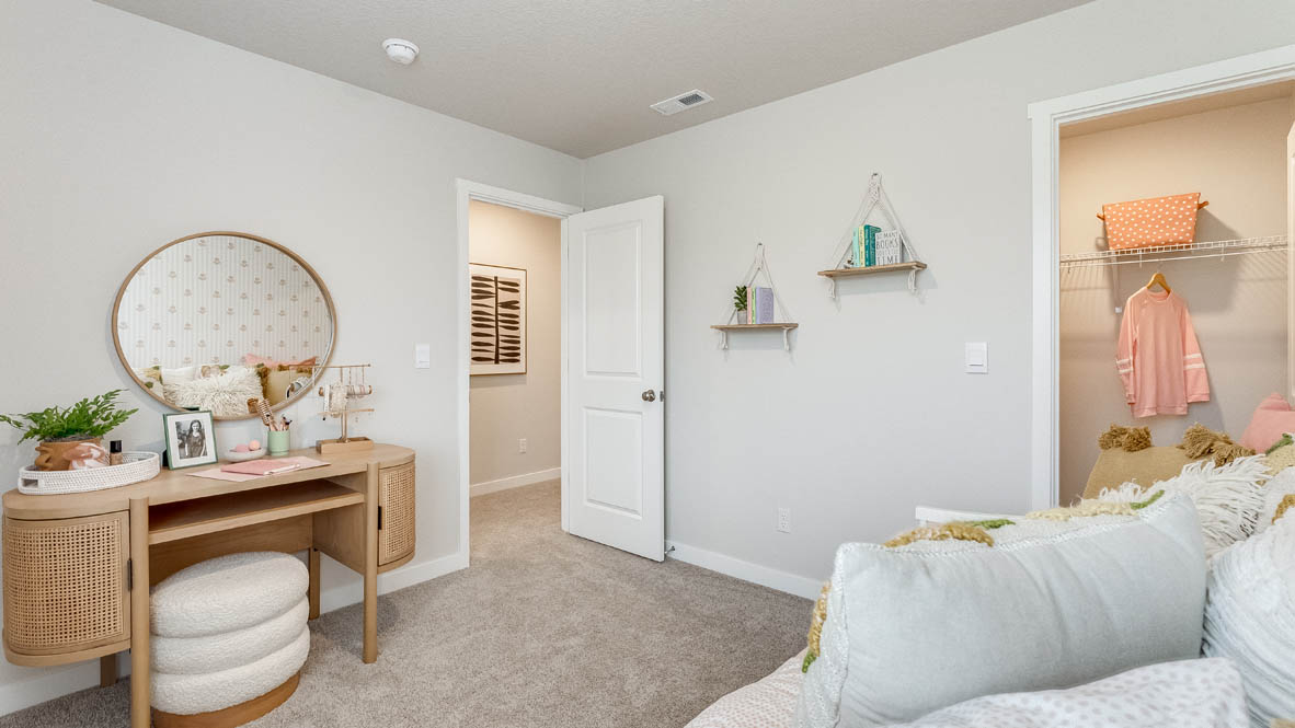 Butler Creek Crossing bedroom with dresser, circle mirror, carpeting, white walls, decorative paintings, and white mattress
