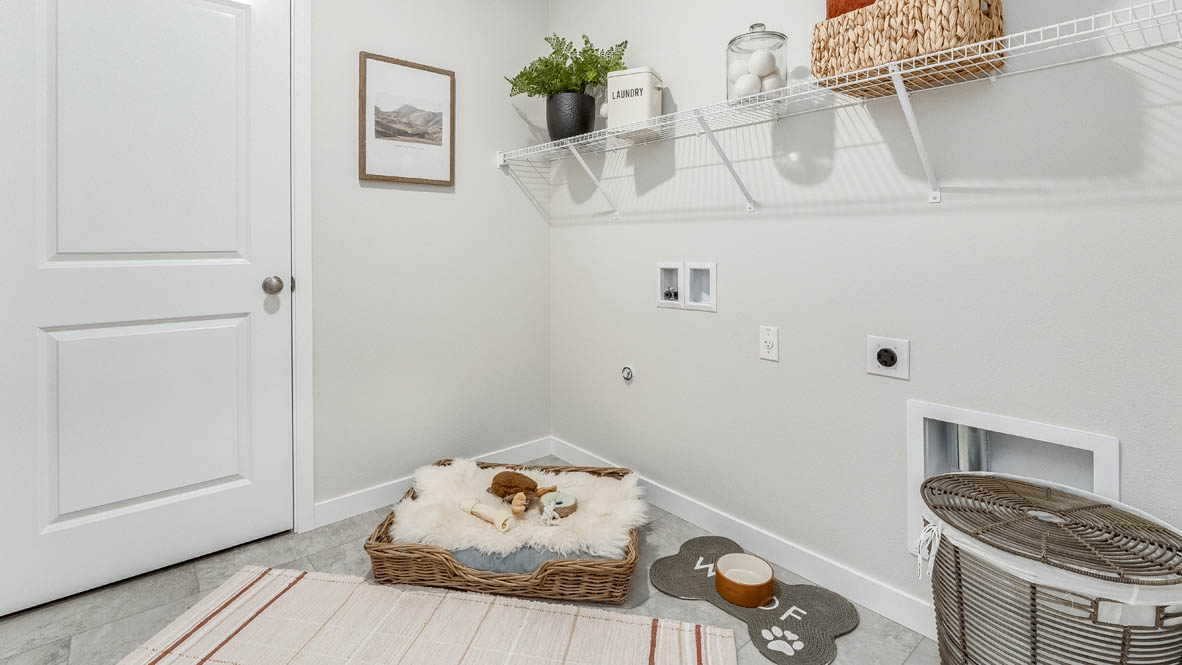 Butler Creek Crossing laundry room with white wire shelving, and a hamper