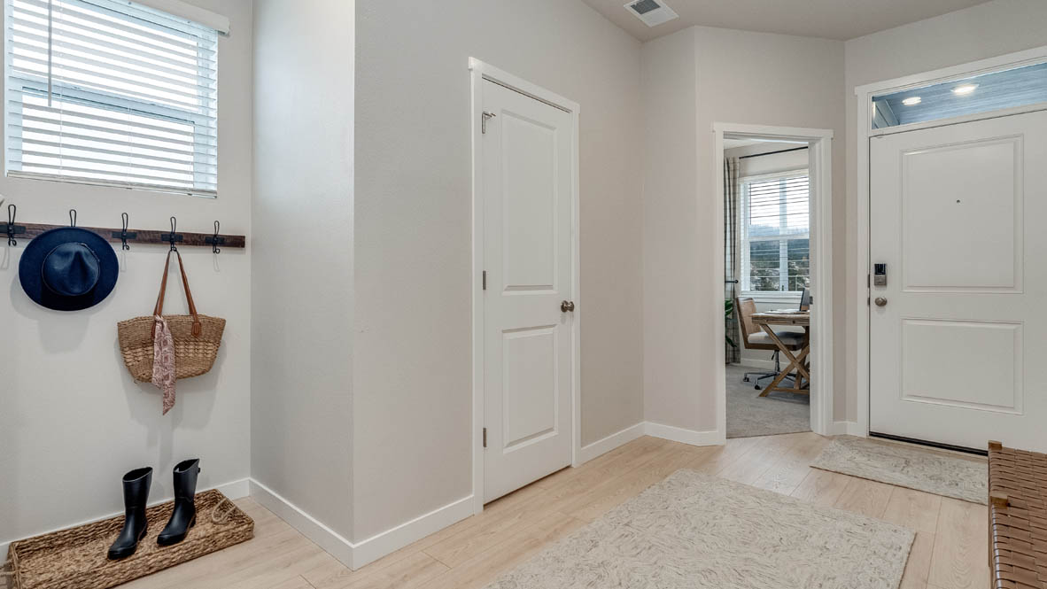 Entryway with a coat closet and laminate flooring