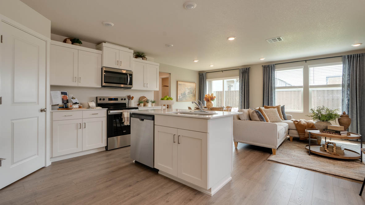 Bailey Meadows kitchen with white shaker style cabinets, solid surface countertops, and stainless steel appliances