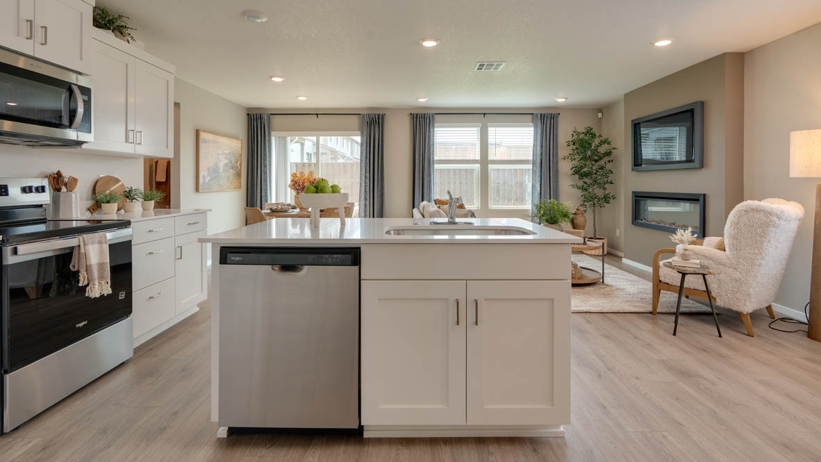 Bailey Meadows kitchen with white shaker style cabinets, solid surface countertops, and stainless steel appliances