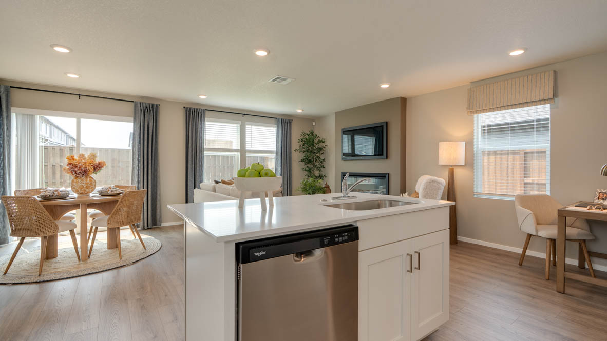 Bailey Meadows kitchen with white shaker style cabinets, solid surface countertops, and stainless steel appliances