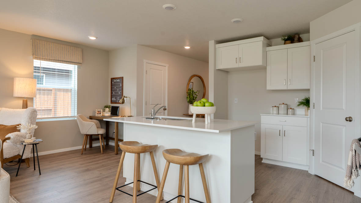 Bailey Meadows kitchen with white shaker style cabinets, solid surface countertops, and stainless steel appliances