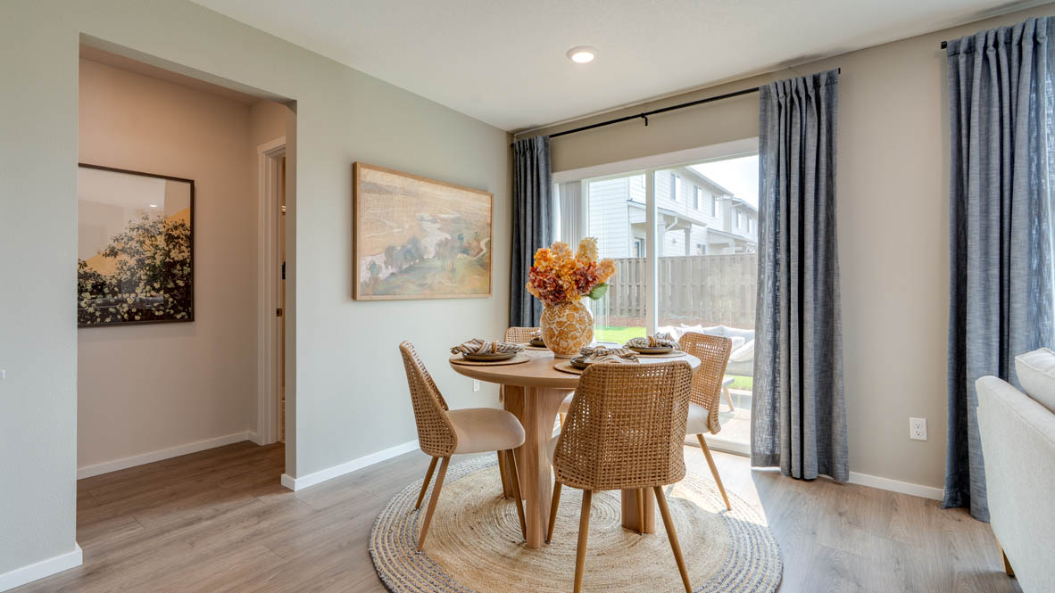 Bailey Meadows dining room with sliding glass door to backyard and table set for four