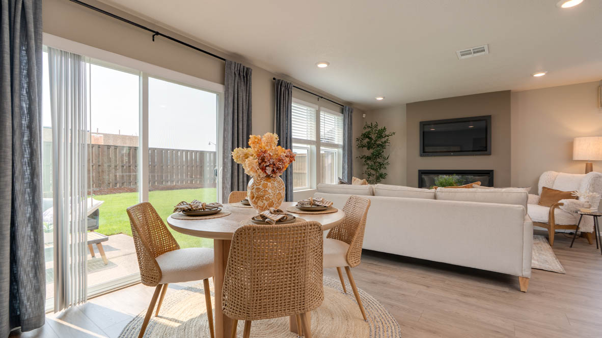 Bailey Meadows dining room with sliding glass door to backyard and table set for four