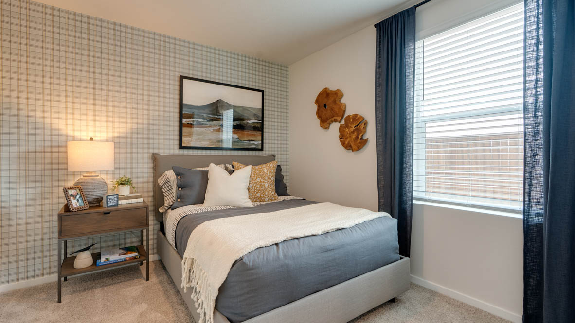 Bailey Meadows bedroom on the main level with carpeting and an en suite bathroom