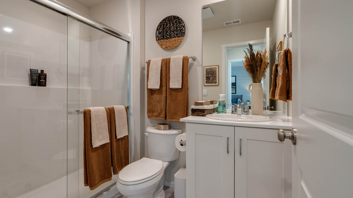 Bailey Meadows full bathroom on the main level with walk in shower and single sink vanity