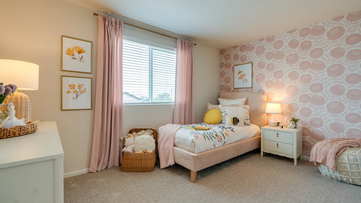 Bailey Meadows bedroom with pink decor and twin bed and carpeting