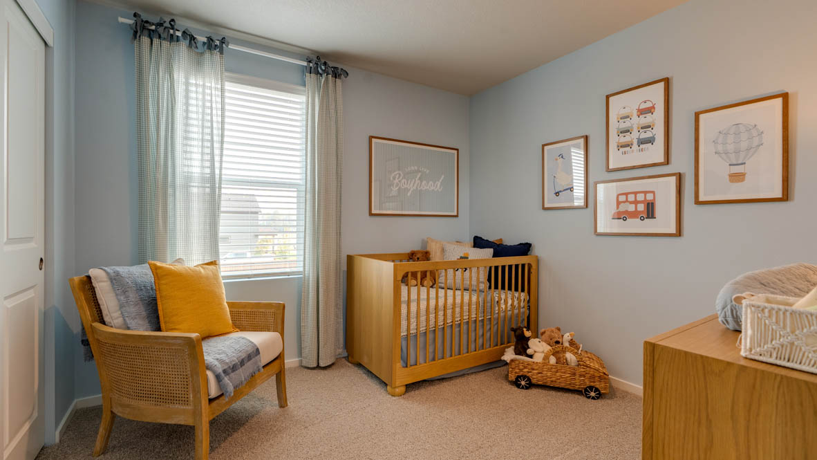 Bailey Meadows bedroom with a crib and carpeting