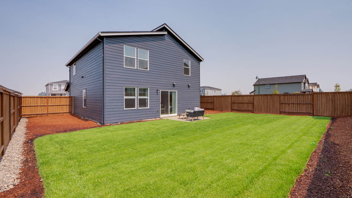 Bailey Meadows backyard with grass and outdoor patio furniture